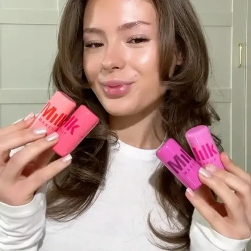 Model showcasing Cooling Water Milk Jelly Tint lip and cheek sticks in pink and purple shades.